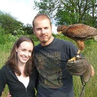 Couple holding Harris Hawk