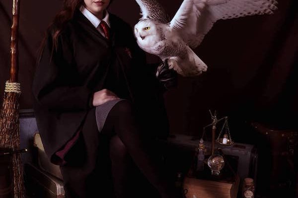 Harry Potter themed photoshoot with girl in Hogwarts robes but broom holding Snowy Owl